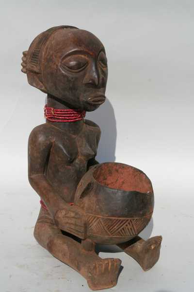 Luba (porteur de coupe), d`afrique : rep.dem.Congo, statuette Luba (porteur de coupe), masque ancien africain Luba (porteur de coupe), art du rep.dem.Congo - Art Africain, collection privées Belgique. Statue africaine de la tribu des Luba (porteur de coupe), provenant du rep.dem.Congo, 1413/1068.Porteuse de coupe Luba,assise tenant une coupe qui a contenu la poudre sacrée rouge(tukula).Elle porte des colliers de petites perles rouges;une coiffure cruciforme. Très belle et ancienne statue du 19eme début 20eme sc.(attelier de la basse Lukuga) h.47cm.parfois appelée mendiante.
(col.Verwilghen)

Zittende kruikdraagster,die rode tukula poeder draagt en bij waarzegsrituelen gebruikt werd.h.47cm.Haar weelderig kapsel  gevlochten in kruisvorm is opmerkelijk.Ze draagt een halssnoer met kleine rode parels
Attelier de la basse Lukuga;begin 20ste eeuw
Ook bedelaarster genoemd.. art,culture,masque,statue,statuette,pot,ivoire,exposition,expo,masque original,masques,statues,statuettes,pots,expositions,expo,masques originaux,collectionneur d`art,art africain,culture africaine,masque africain,statue africaine,statuette africaine,pot africain,ivoire africain,exposition africain,expo africain,masque origina africainl,masques africains,statues africaines,statuettes africaines,pots africains,expositions africaines,expo africaines,masques originaux  africains,collectionneur d`art africain